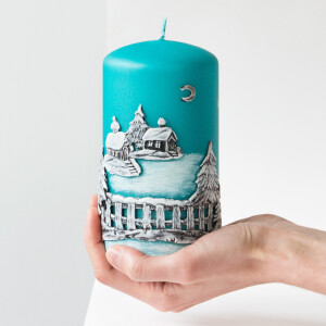 Dicke, türkise Stumpenkerze zu Weihnachten mit einem Wachsmotiv in Handarbeit